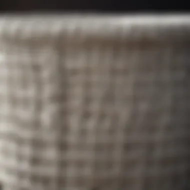 Close-up of the intricate weave of a large white wicker laundry basket