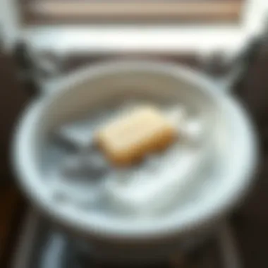 Soaking laundry in a basin with soap bar